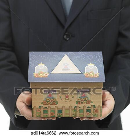 Stock Image - person, body, hand, closeup, object, toy, house. Fotosearch