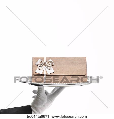 Stock Image - person, body, hand, closeup, object, gloves, silver plate. Fotosearch