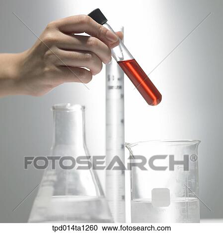Stock Image - person, body, hand, closeup, science, experiment, beaker. Fotosearch