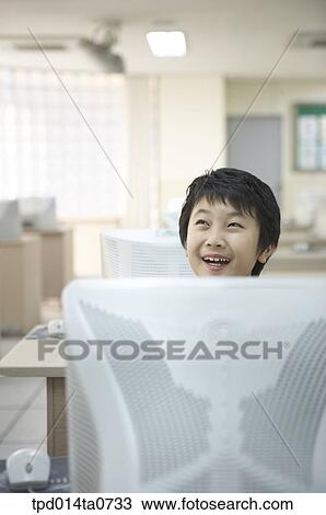Stock Image - classroom, education, Asian, smile, person, thought. Fotosearch