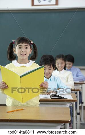 Stock Image - classroom, education, Asian, smile, announcement, person. Fotosearch