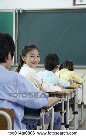 Stock Photograph - classroom, education, turning back, Asian, smile, person. Fotosearch