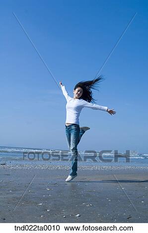 a jumping woman in a seashore View Large Photo Image Stock Image - a jumping woman in a seashore. Fotosearch