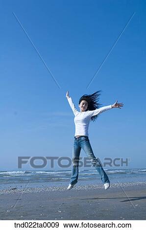 a jumping woman in a seashore View Large Photo Image Stock Photo - a jumping woman in a seashore. Fotosearch