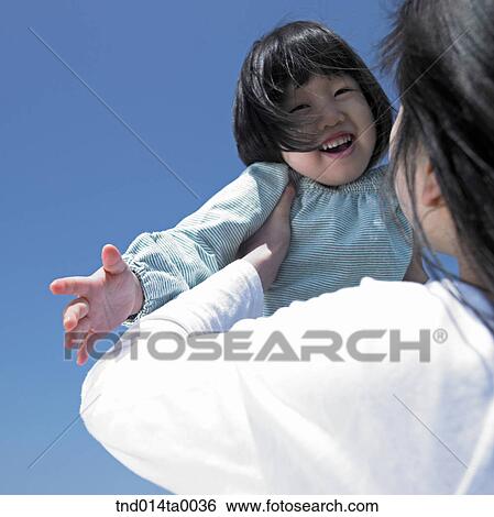 Stock Photograph - a smiling child and a woman. Fotosearch