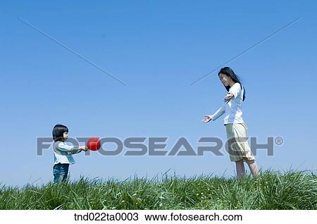 Stock Image - a woman and a child holding a balloon. Fotosearch
