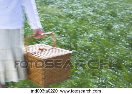 a woman holding a lunch box View Large Photo Image Stock Image - a woman holding a lunch box. Fotosearch