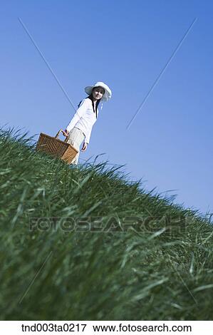 Stock Photo - a woman holding a lunch box. Fotosearch