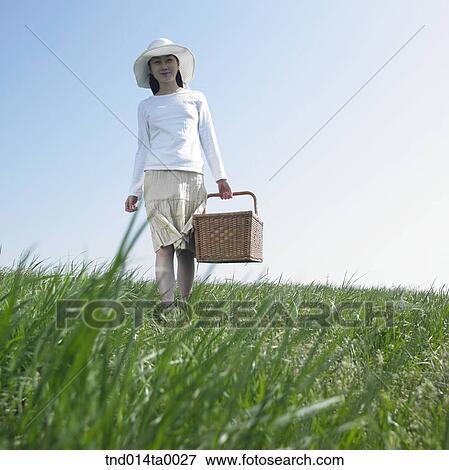Stock Photo - a woman holding a lunch box. Fotosearch