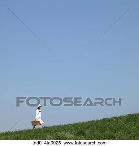 a woman holding a lunch box View Large Photo Image Stock Photography - a woman holding a lunch box. Fotosearch