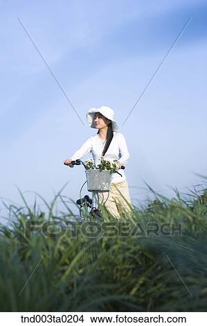 a woman riding a bicyble View Large Photo Image Picture - a woman riding a bicyble. Fotosearch
