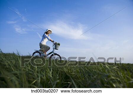 a woman riding a bicyble View Large Photo Image Stock Photo - a woman riding a bicyble. Fotosearch