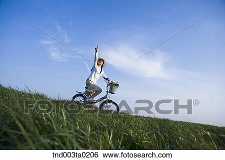 a woman riding a bicyble View Large Photo Image Stock Photograph - a woman riding a bicyble. Fotosearch