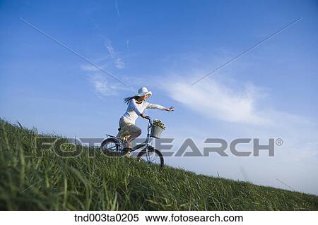 Stock Photography - a woman riding a bicyble. Fotosearch