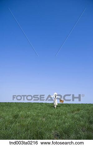 a woman's back holding a lunch box View Large Photo Image Stock Photograph - a woman's back holding a lunch box. Fotosearch