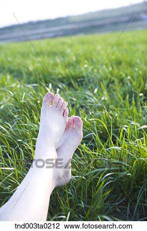 Stock Image - feets on a grass. Fotosearch