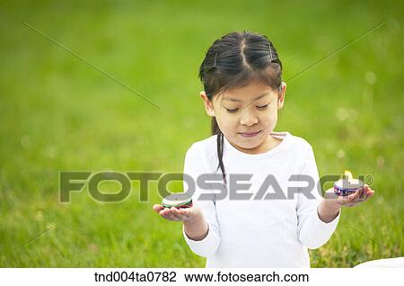 a child holding an incense burner View Large Photo Image Stock Image - a child holding an incense burner. Fotosearch