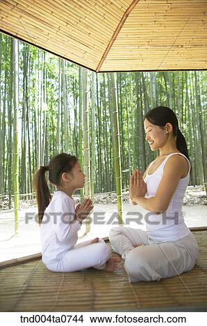 a mother and a child doing Yoga at a pavilion in a bamboo tree forest View Large Photo Image Picture - a mother and a child doing Yoga at a pavilion in a bamboo tree forest. Fotosearch
