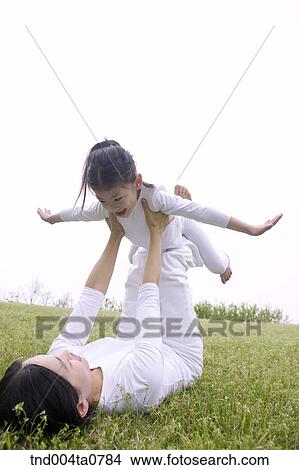 a mother and a child doing Yoga View Large Photo Image Picture - a mother and a child doing Yoga. Fotosearch