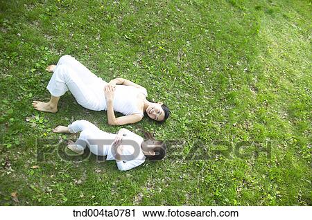 a mother and a child talking each other on the grass View Large Photo Image Stock Image - a mother and a child talking each other on the grass. Fotosearch