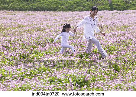 a walking mother and a child in a flower garden View Large Photo Image Stock Image - a walking mother and a child in a flower garden. Fotosearch