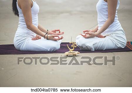 Stock Photography - a woman doing Yoga and an incense burner. Fotosearch