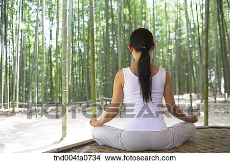 a woman doing Yoga at a pavilion in a bamboo tree forest View Large Photo Image Picture - a woman doing Yoga at a pavilion in a bamboo tree forest. Fotosearch