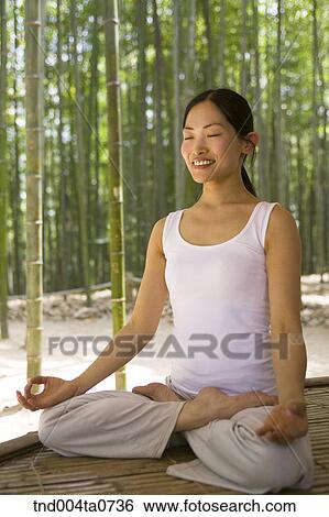 a woman doing Yoga at a pavilion in a bamboo tree forest View Large Photo Image Stock Photograph - a woman doing Yoga at a pavilion in a bamboo tree forest. Fotosearch