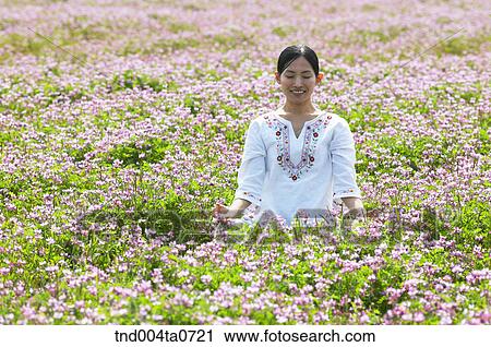 a woman doing Yoga in a flower garden View Large Photo Image Stock Image - a woman doing Yoga in a flower garden. Fotosearch