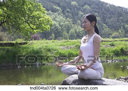 a woman doing Yoga in a flower garden View Large Photo Image Stock Photograph - a woman doing Yoga in a flower garden. Fotosearch