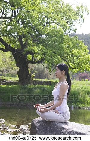 a woman doing Yoga in a flower garden View Large Photo Image Stock Photography - a woman doing Yoga in a flower garden. Fotosearch