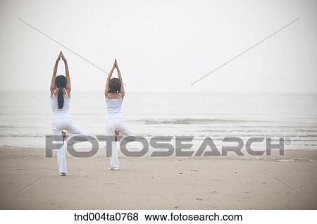 a woman doing Yoga in a seashore View Large Photo Image Stock Photo - a woman doing Yoga in a seashore. Fotosearch
