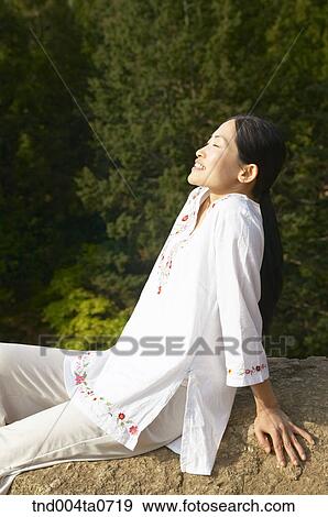 a woman doing Yoga in a tea field View Large Photo Image Stock Photo - a woman doing Yoga in a tea field. Fotosearch