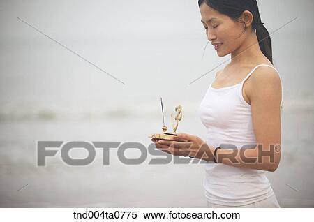 a woman holding an incense burner View Large Photo Image Stock Photography - a woman holding an incense burner. Fotosearch