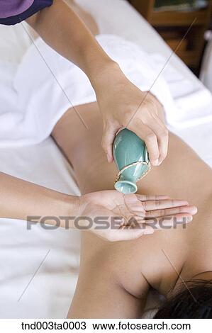spa/ a massager putting an oil View Large Photo Image Stock Image - spa/ a massager putting an oil. Fotosearch