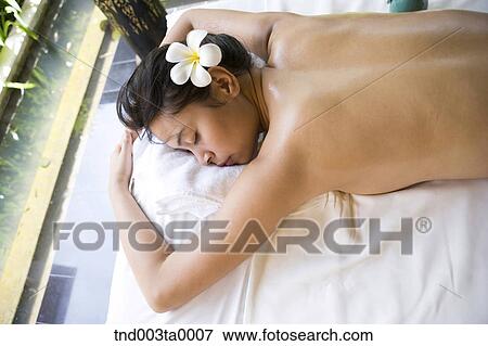 spa/ a woman lying on a massage table View Large Photo Image Stock Photo - spa/ a woman lying on a massage table. Fotosearch
