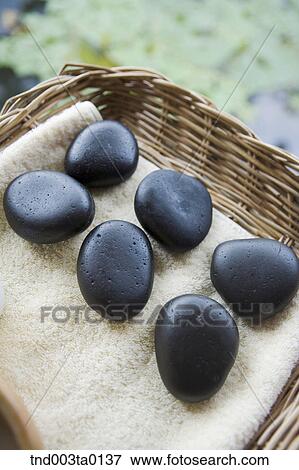 spa, pebbles on a basket View Large Photo Image Stock Photo - spa, pebbles on a basket. Fotosearch