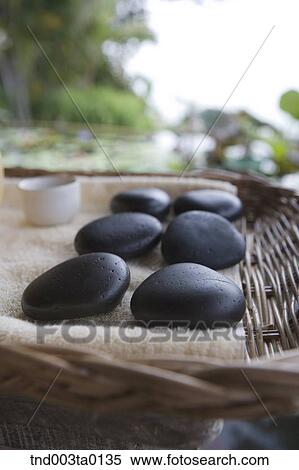 spa, pebbles on a basket View Large Photo Image Stock Photography - spa, pebbles on a basket. Fotosearch