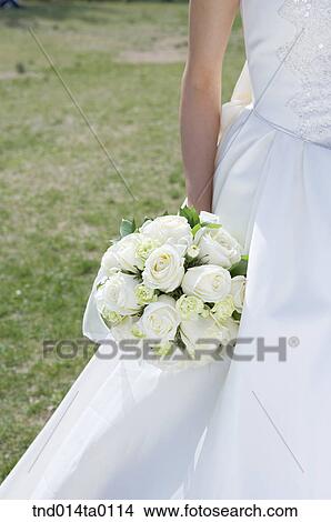 Wedding, a bride holding a bouquet View Large Photo Image Picture - Wedding, a bride holding a bouquet. Fotosearch
