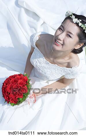 Wedding, a bride holding a bouquet View Large Photo Image Stock Image - Wedding, a bride holding a bouquet. Fotosearch