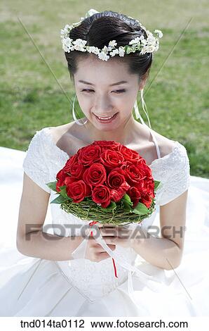 Stock Image - Wedding, a bride holding a bouquet. Fotosearch
