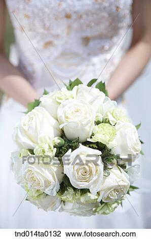 Wedding, a bride holding a bouquet View Large Photo Image Stock Image - Wedding, a bride holding a bouquet. Fotosearch
