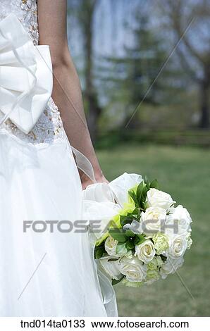 Wedding, a bride holding a bouquet View Large Photo Image Stock Image - Wedding, a bride holding a bouquet. Fotosearch
