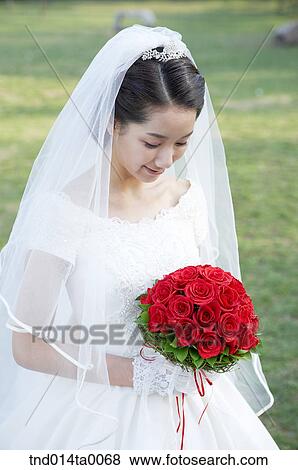Wedding, a bride holding a bouquet View Large Photo Image Stock Photo - Wedding, a bride holding a bouquet. Fotosearch