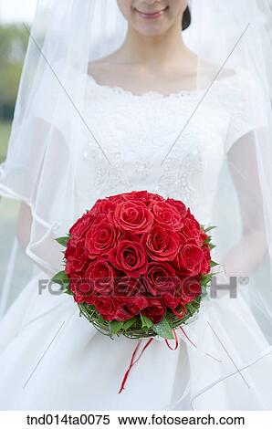 Wedding, a bride holding a bouquet View Large Photo Image Stock Photography - Wedding, a bride holding a bouquet. Fotosearch