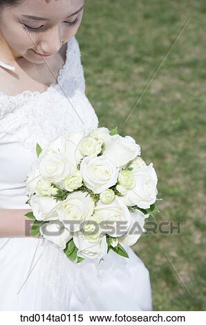 Wedding, a bride holding a bouquet View Large Photo Image Stock Photography - Wedding, a bride holding a bouquet. Fotosearch