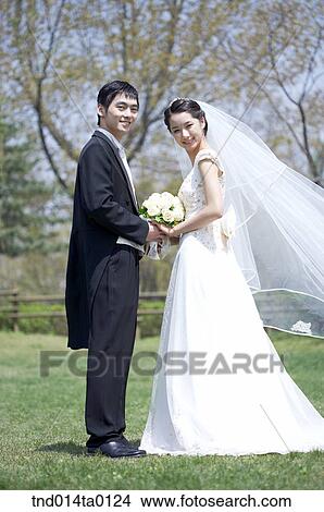 Wedding, a bridegroom holding a bouquet View Large Photo Image Picture - Wedding, a bridegroom holding a bouquet. Fotosearch