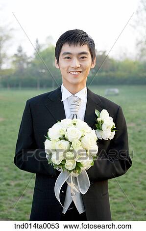 Wedding, a bridegroom holding a bouquet View Large Photo Image Stock Image - Wedding, a bridegroom holding a bouquet. Fotosearch