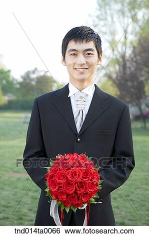 Wedding, a bridegroom holding a bouquet View Large Photo Image Stock Photograph - Wedding, a bridegroom holding a bouquet. Fotosearch