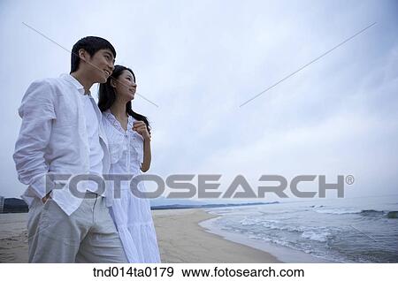 couple are in the seashore View Large Photo Image Stock Photo - couple are in the seashore. Fotosearch